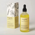 Veganic hair growth oil vegan natural essential treatment in a clear glass bottle with black dropper cap and golden-yellow liquid
