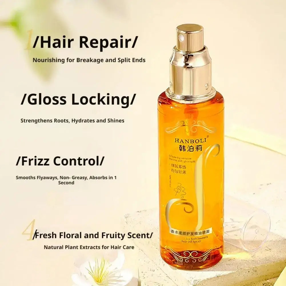 A sleek transparent bottle of amber hanboli hair oil spray with golden nozzle for frizz control and hydration