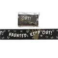 Black halloween caution tape with white spooky faces and haunted keep out text for party warning barrier