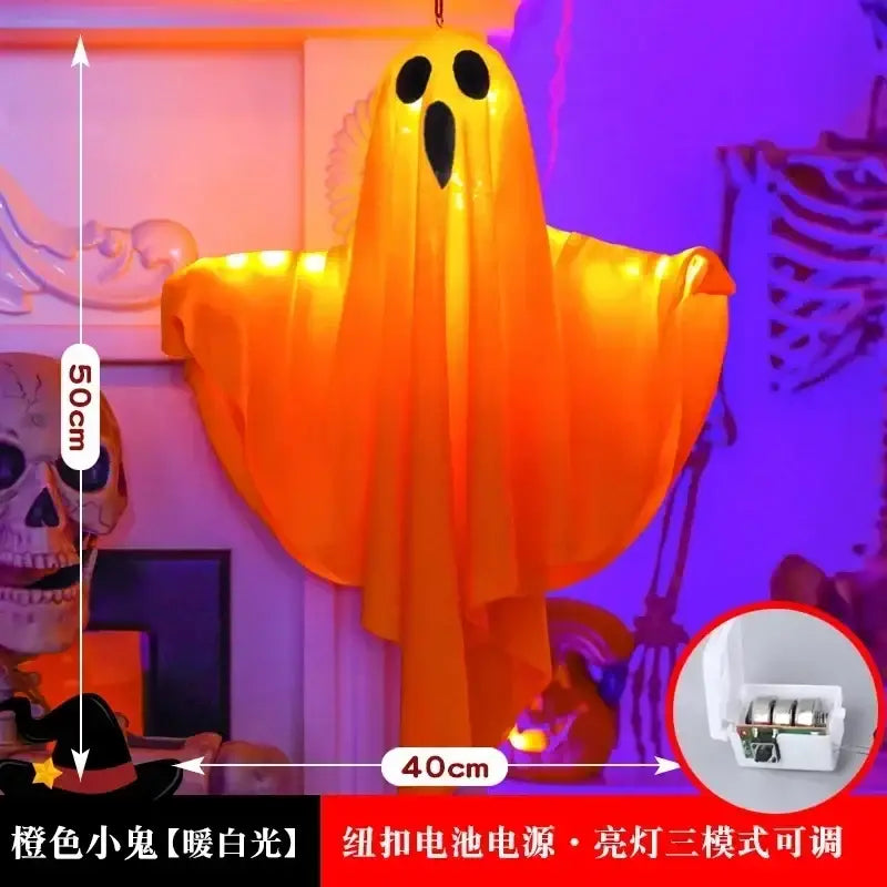A glowing orange inflatable halloween decoration ghost with black cutouts illuminated by warm white led lights