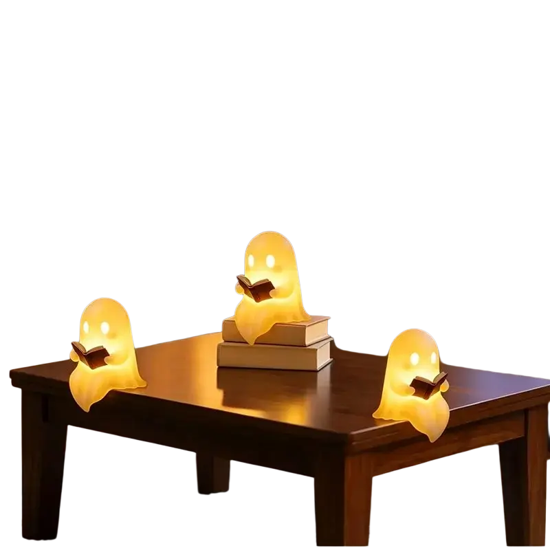 Three glowing yellow translucent ghost led lamps holding books on wood table halloween desktop luminous reading ornament