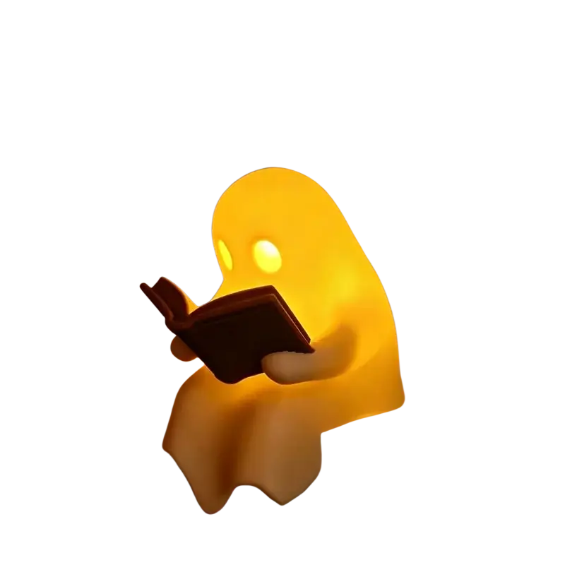 A glowing yellow halloween desktop luminous ghost nightlight holding a dark book for desktop luminous reading use