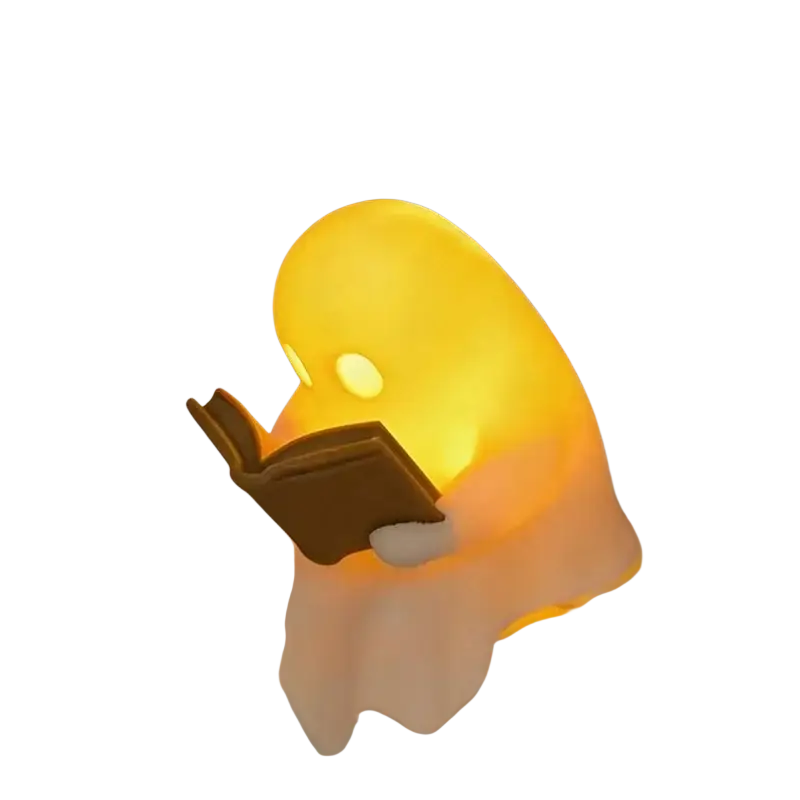 A glowing yellow halloween desktop luminous ghost lamp with a translucent body holding an open book for reading