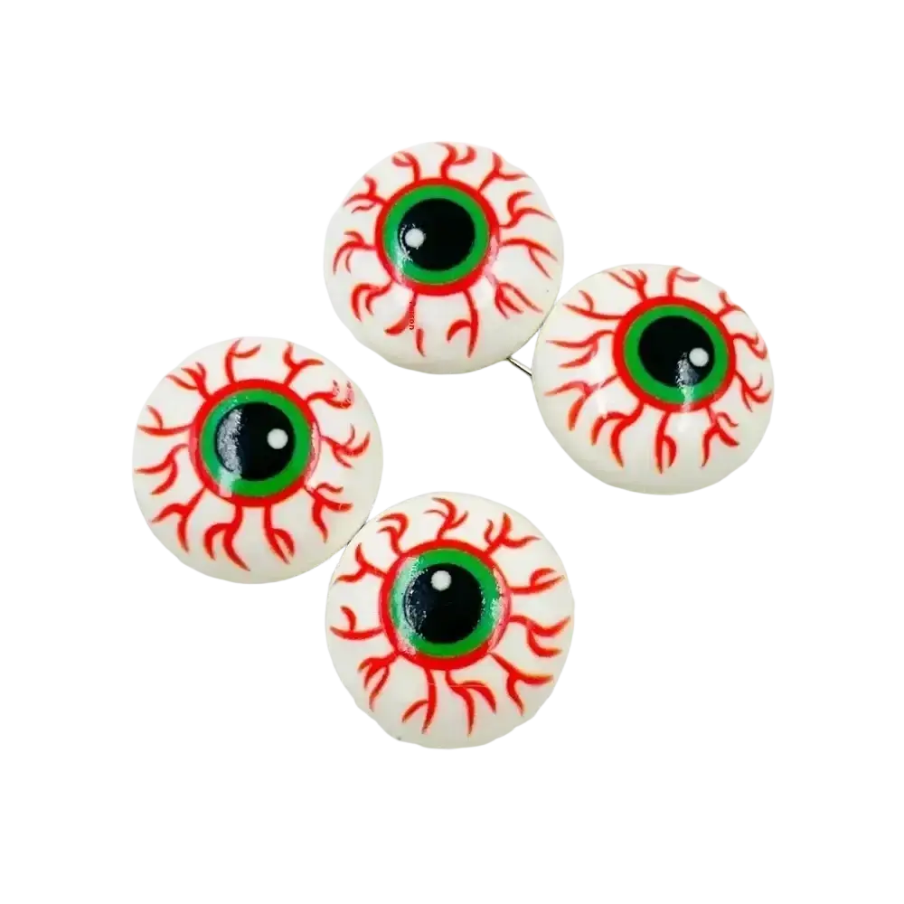 White plastic halloween eyeball ornaments and hairpins with red veins, green irises, and black pupils