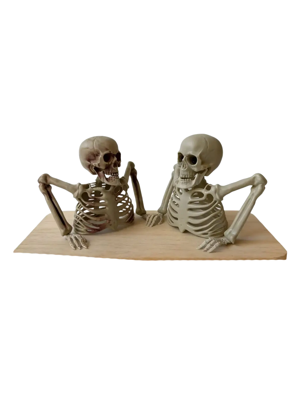 Two beige painted halloween half skeleton decoration figurines with detailed bone structures on wooden base for terrifying scene