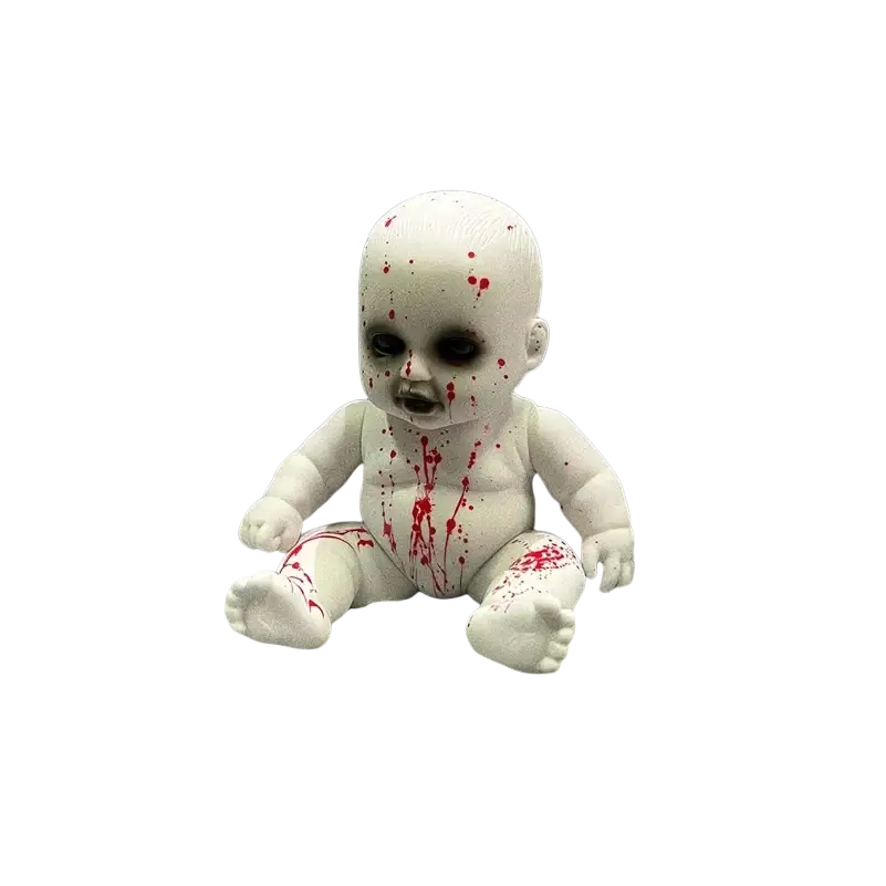 White plastic halloween hanging ghost doll with red splatter details sitting amidst cobwebs and dry grass