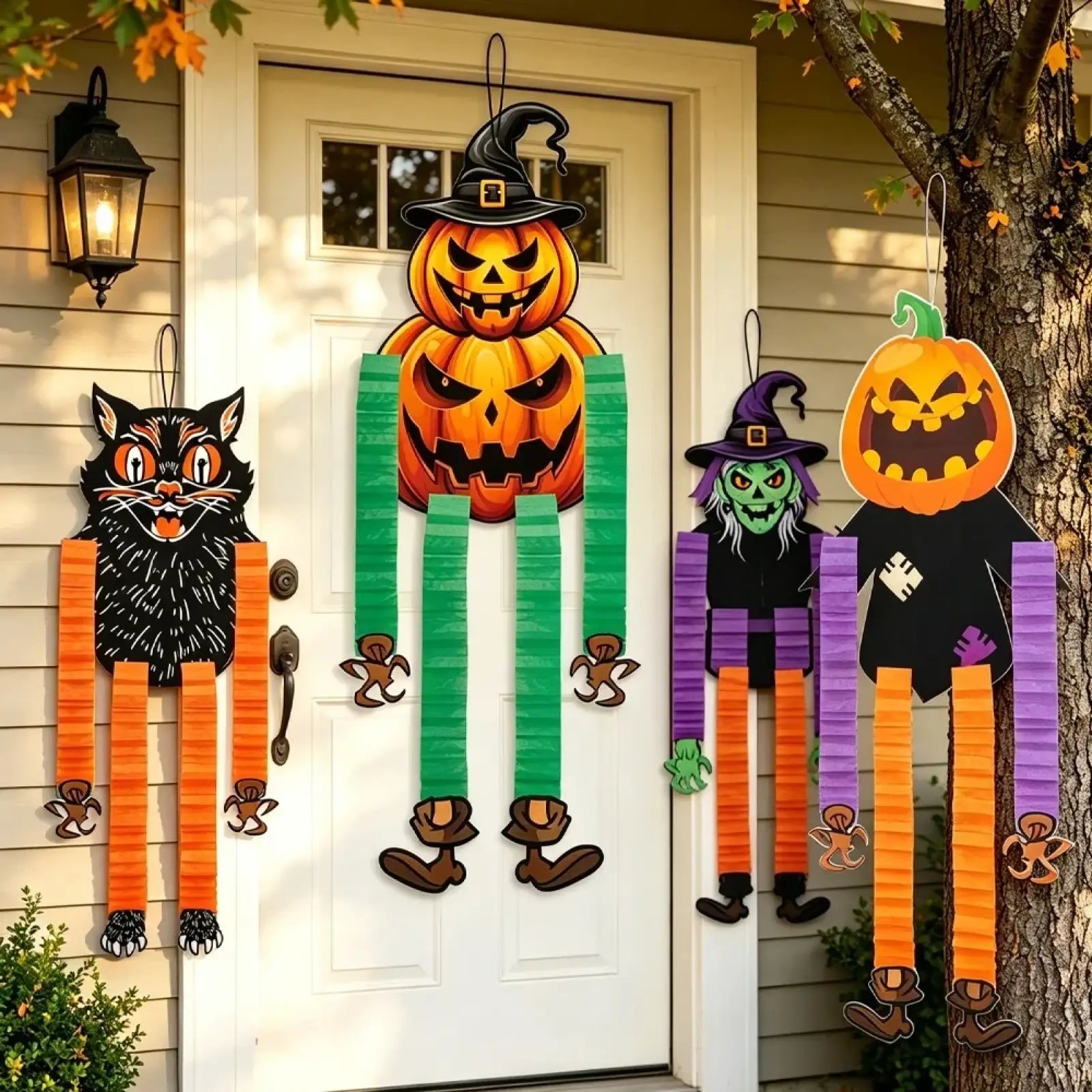 Halloween hanging paper ornaments 4pack featuring orange and green witch pumpkin cat and scarecrow decorations on front door