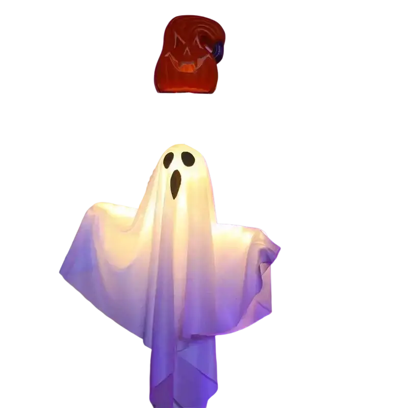 A glowing white halloween led ghost lantern made of translucent fabric with black eye and mouth cutouts hanging decoration