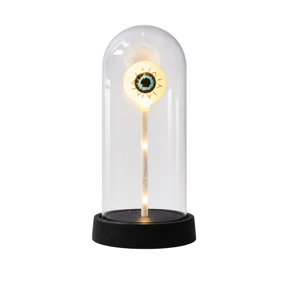 A glowing eye-shaped led lamp in a clear glass dome with black base for halloween lights decorations