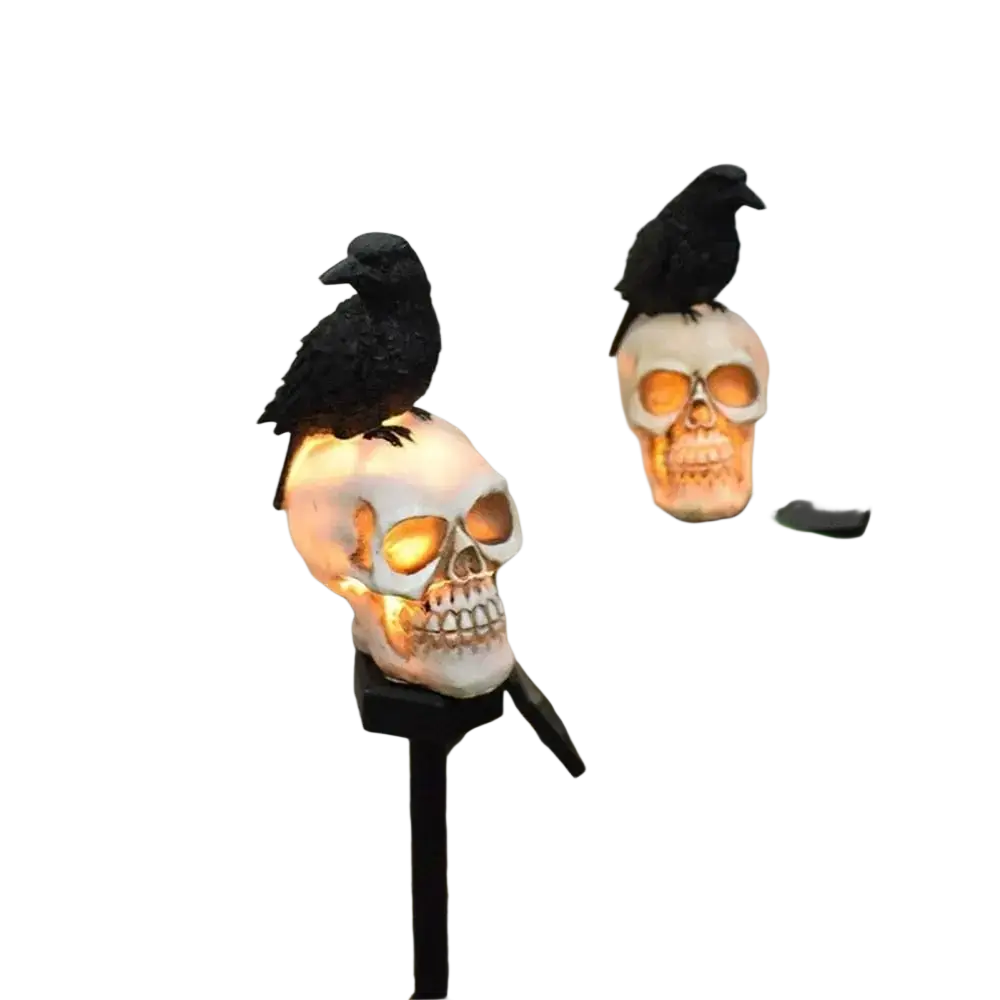 White skull-shaped solar garden stake with glowing orange eyes and black crows for halloween outdoor light holiday lighting