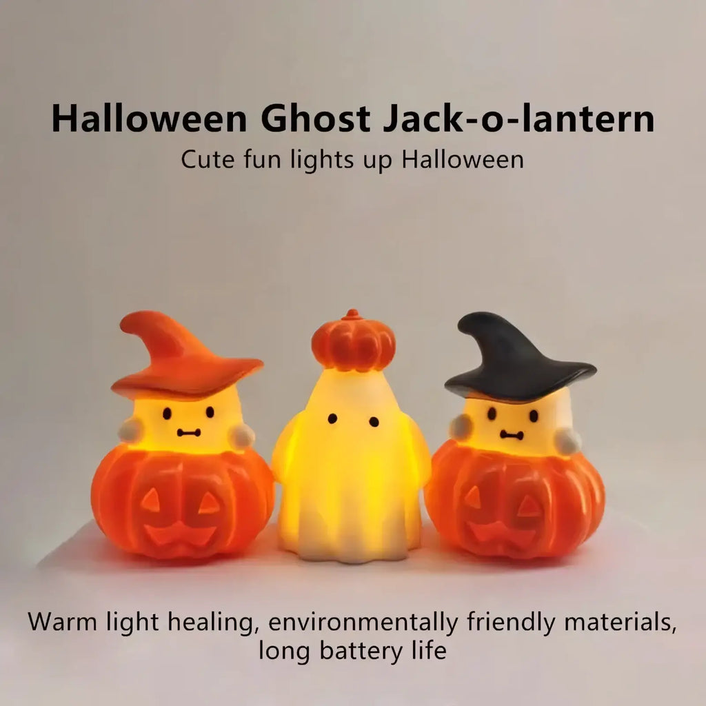 Three illuminated halloween pumpkin ghost night light ornaments with cute faces and orange or black witch hats
