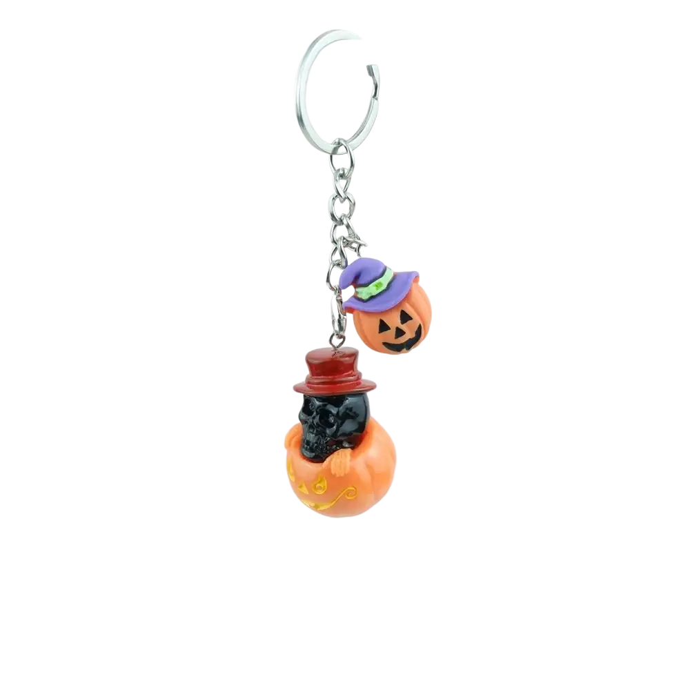 Orange pumpkin shaped handmade resin keychain with black skull in red hat and smaller pumpkin in witch hat for Halloween gift