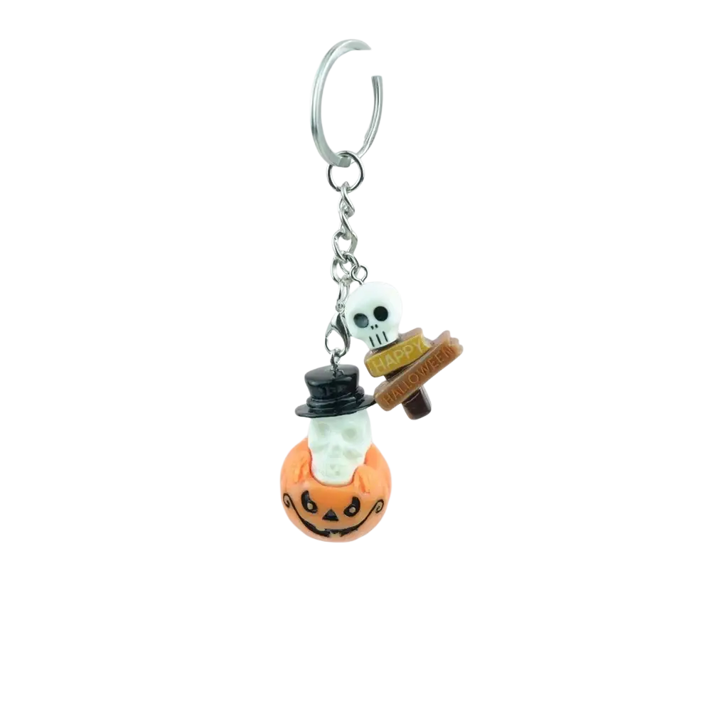 Halloween pumpkin keychain handmade resin jewelry featuring a white skull with black top hat on orange pumpkin