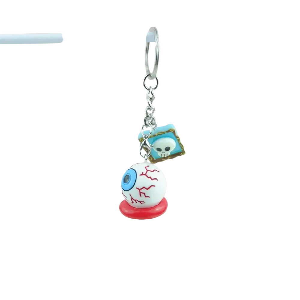 Halloween pumpkin keychain featuring a handmade resin white eyeball with blue eyes red veins on a red base and silver chain
