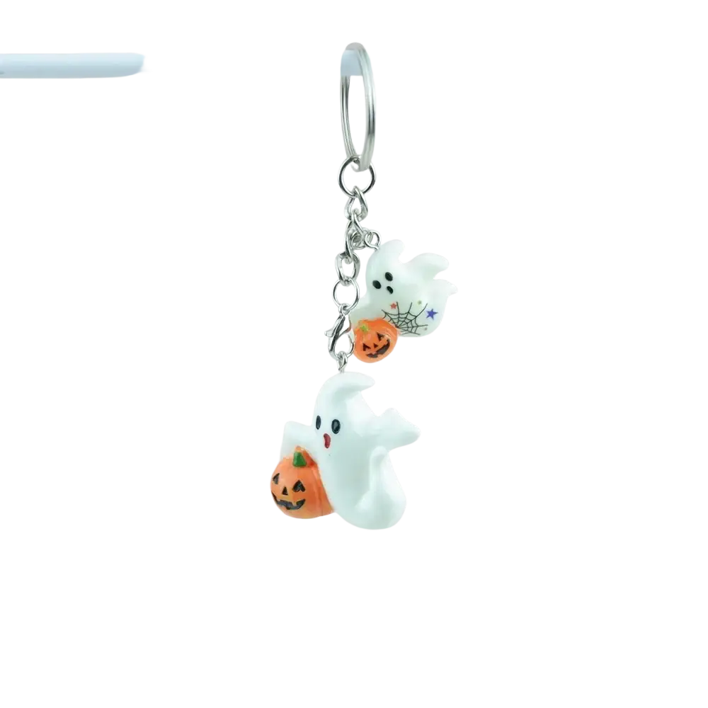 Halloween pumpkin keychain handmade resin jewelry featuring a white ghost with black eyes holding an orange pumpkin charm