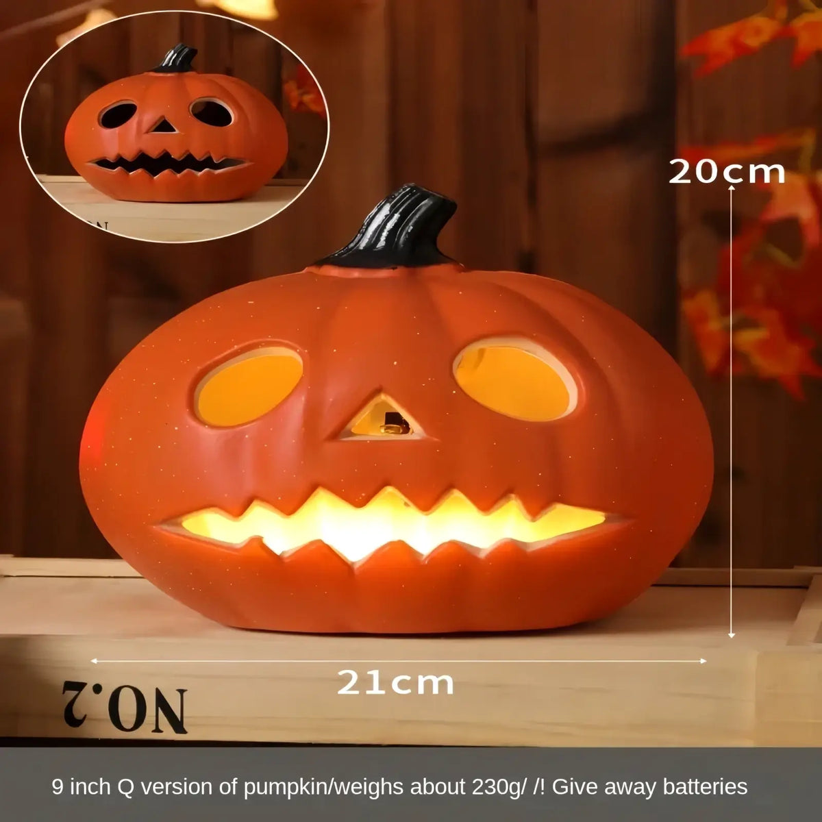 Halloween pumpkin lantern decoration made of orange plastic with black stem and glowing yellow interior light