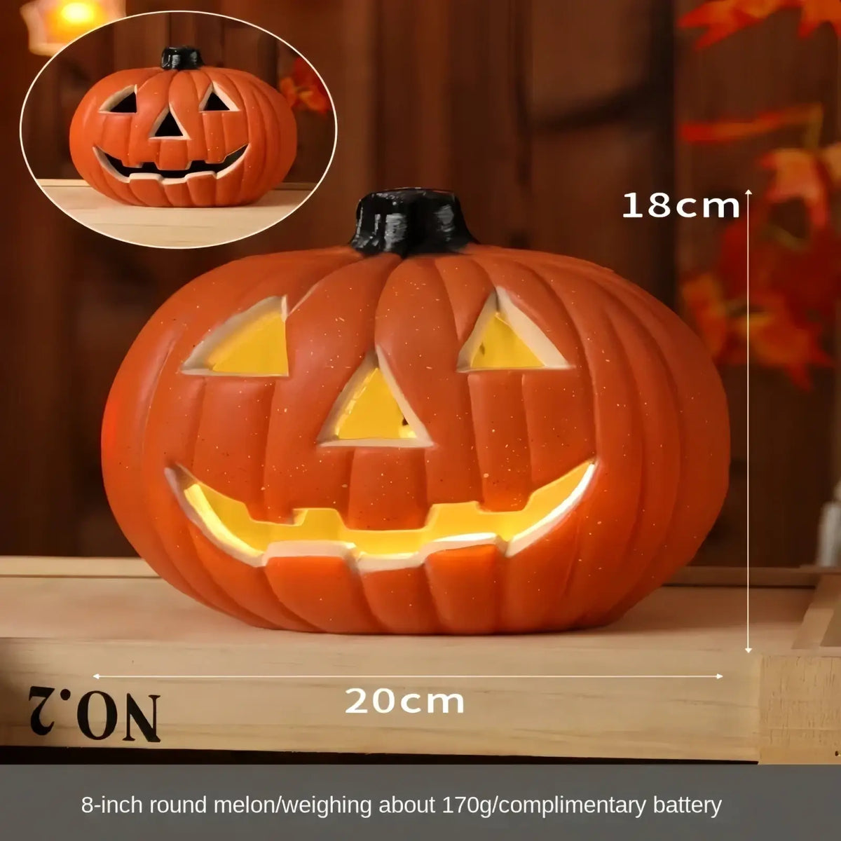Orange plastic halloween pumpkin lantern decoration with black stem and glowing yellow interior light