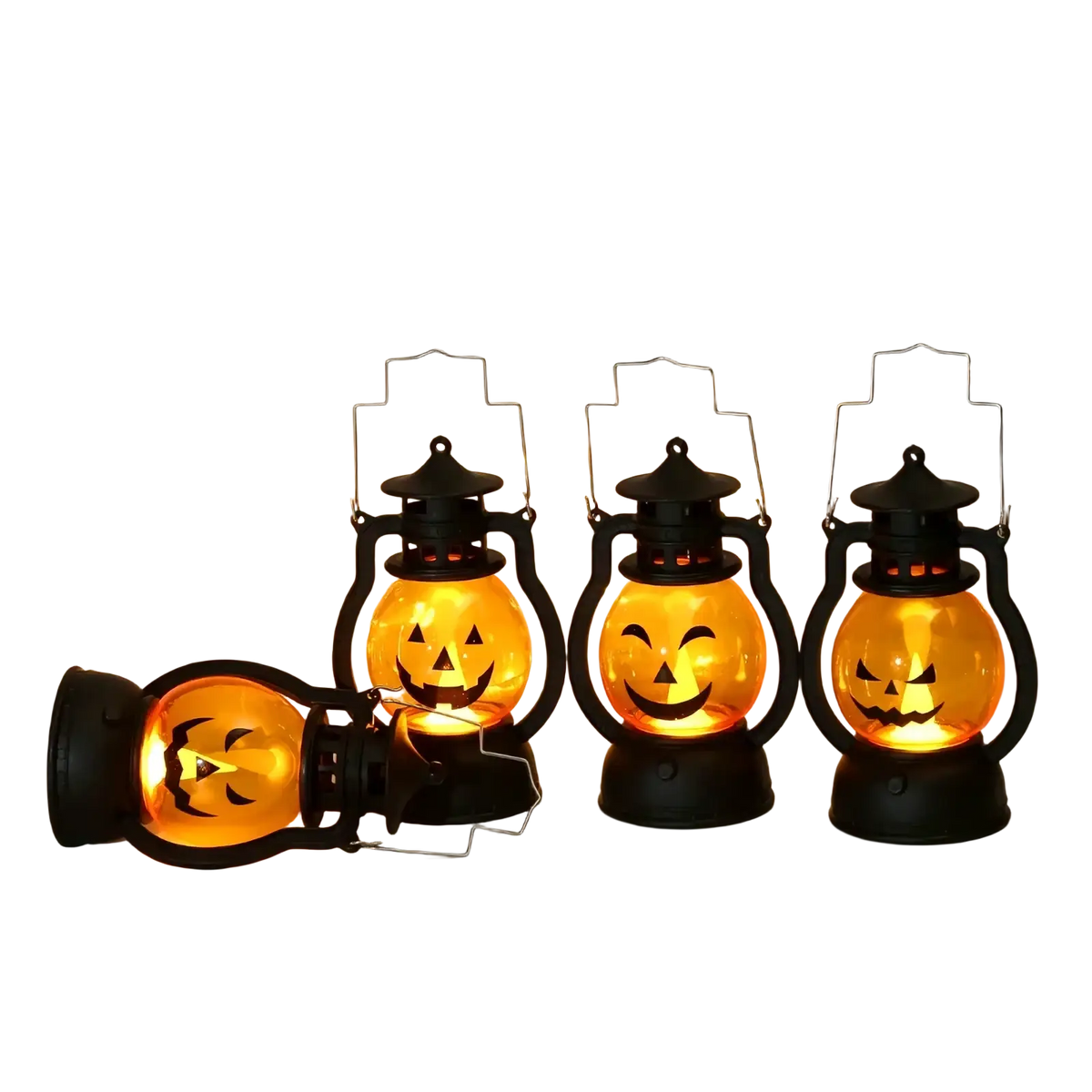 Three black halloween pumpkin led lanterns with glowing orange faces set of four one lying on its side