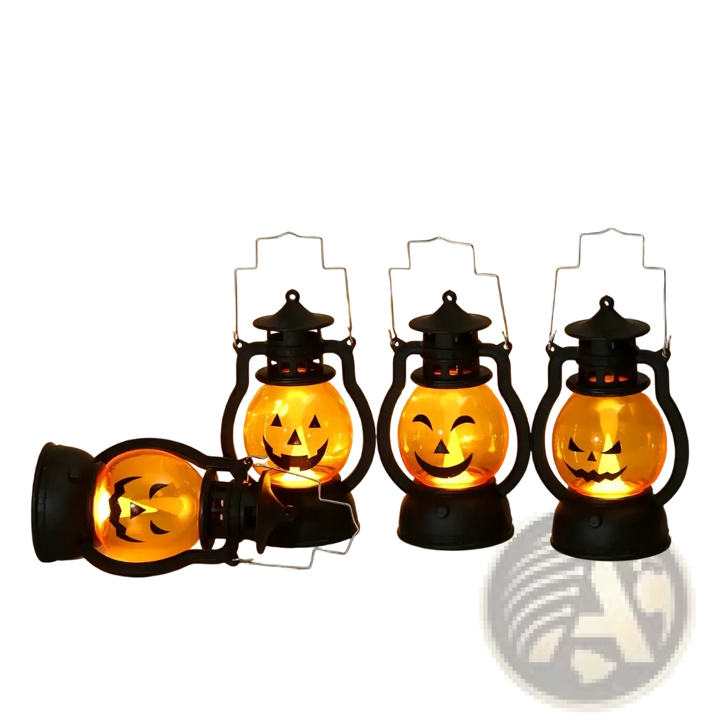 Three black halloween pumpkin led lanterns with glowing orange faces set of four one lying on its side