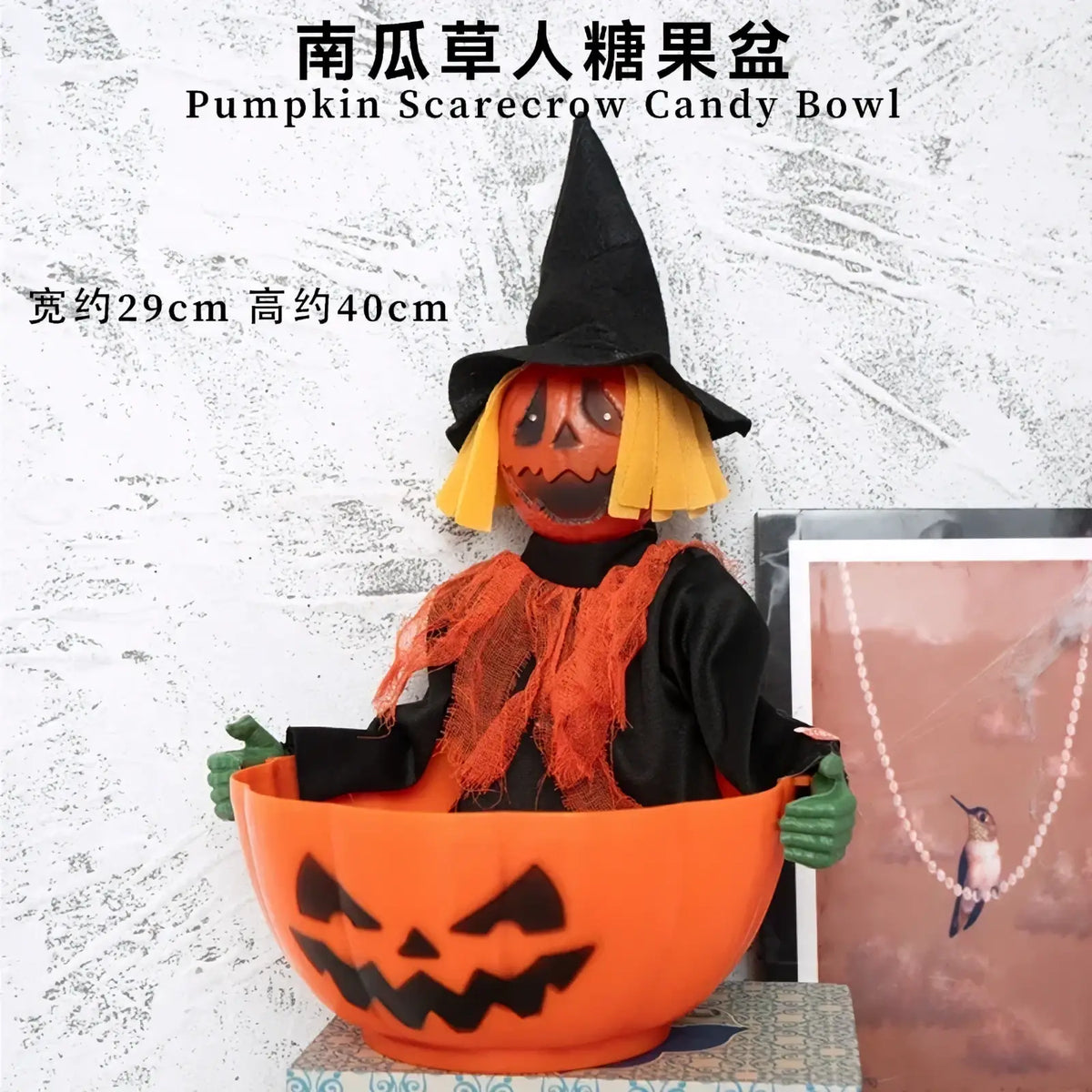 Orange plastic pumpkin scarecrow candy bowl with black witch hat and yellow straw hair for halloween decoration