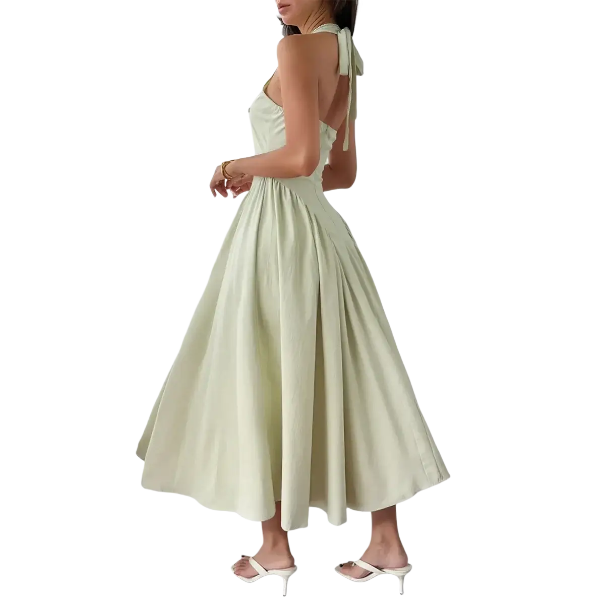 A flowing mint green halter evening dress with a pleated skirt and back tie for elegant autumn wear