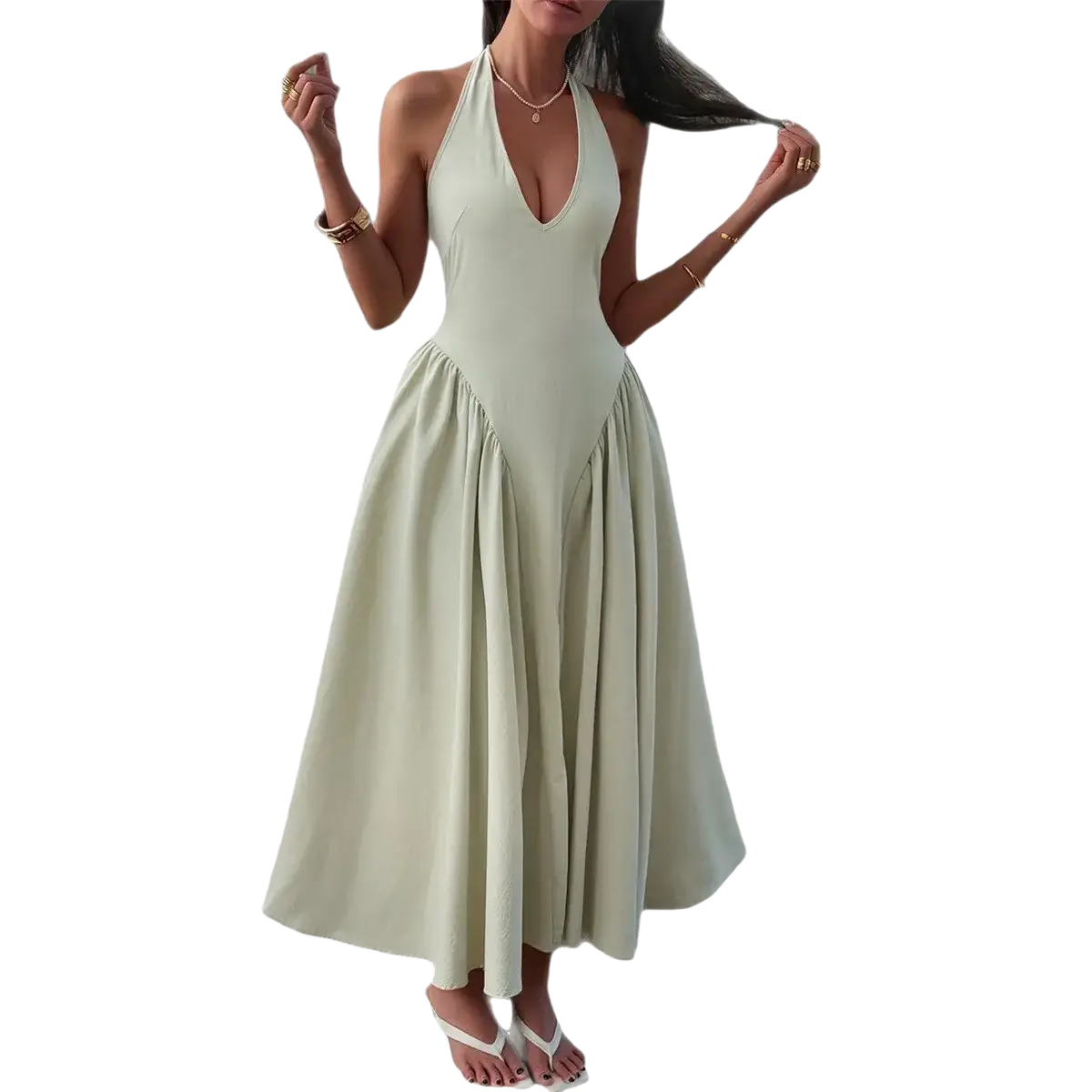 A flowing pale green halter-neck maxi dress with fitted bodice and flared skirt for elegant autumn evenings