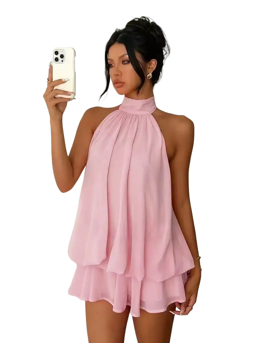A soft pink sleeveless halter neck mini dress with layered ruffles perfect for summer beachwear