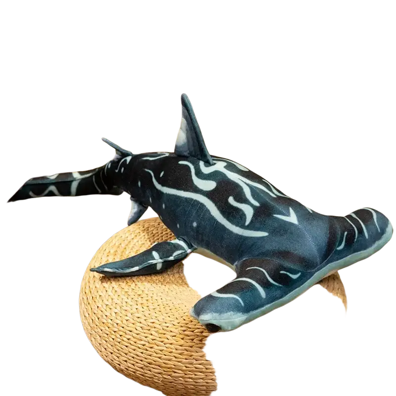 A dark blue hammerhead shark plush pillow soft toy with white flame patterns resting on a woven circular stool