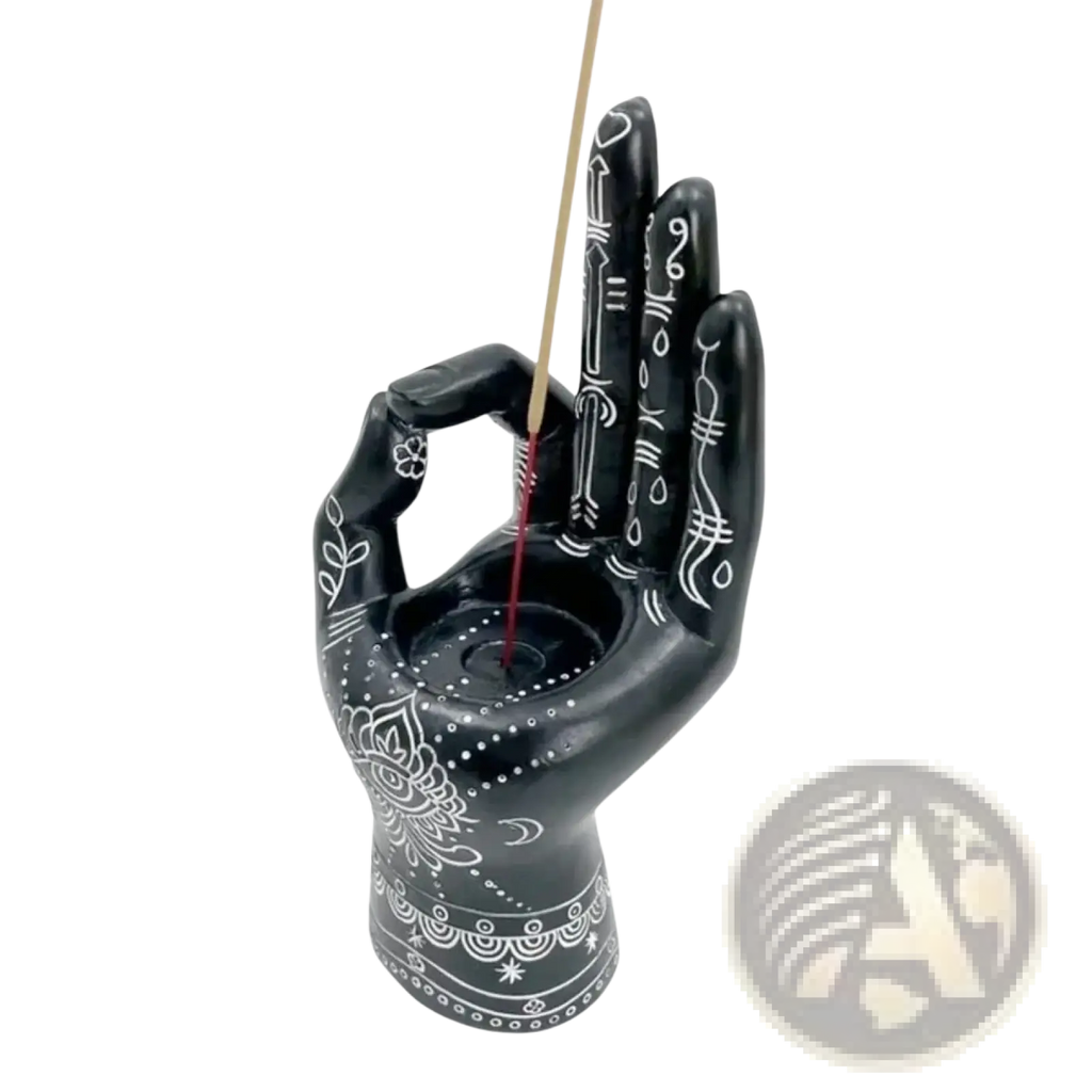 Black hamsa hand incense burner with intricate white patterns used as incense holder and candle figurine