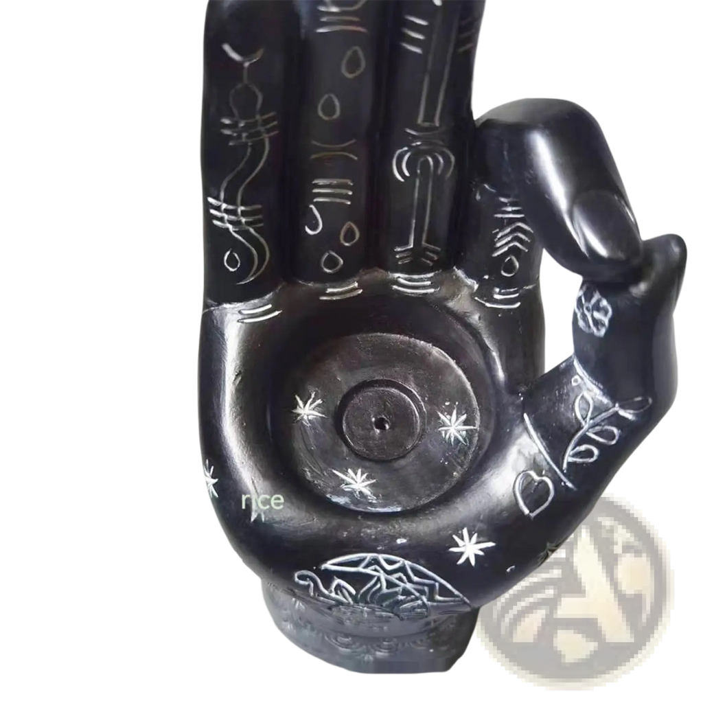 Black hamsa hand incense burner and candle holder figurine with intricate white engraved symbols and patterns