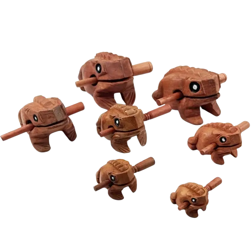 Hand carved wooden frog instrument with smooth warm brown rain wood finish and black circular eyes for home decor