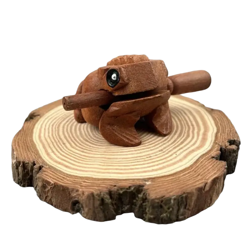 Hand carved wooden frog instrument with smooth warm brown rain wood finish and detailed black rimmed frog body features