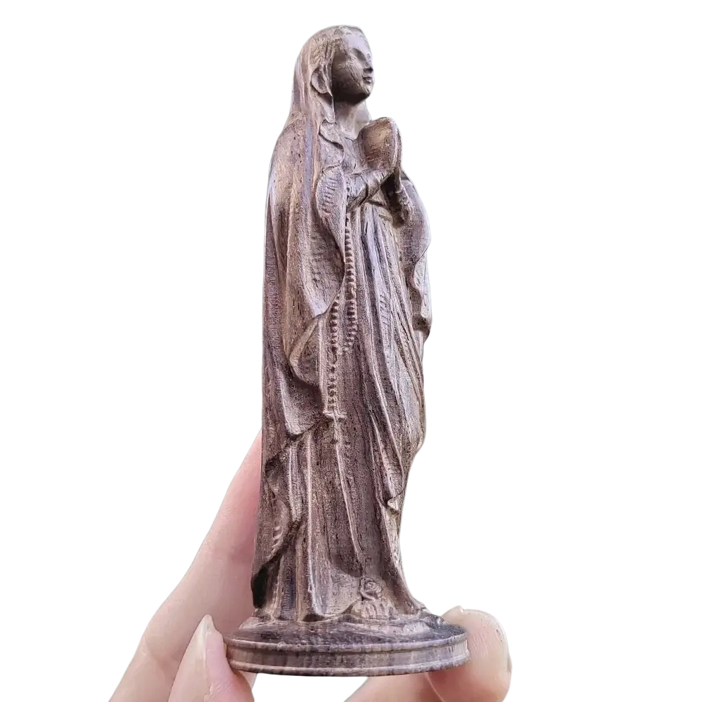 Hand carved wooden virgin mary figurine in warm brown finish holding a rosary with intricate robed carvings