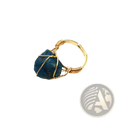Handcrafted adjustable gold wire wrapped ring featuring a raw deep blue gemstone centerpiece