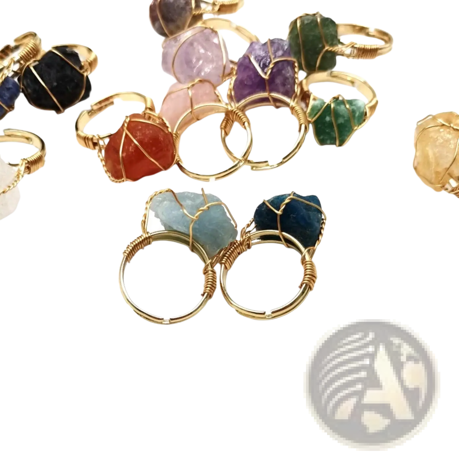 A collection of handcrafted raw gemstone adjustable rings with colorful stones wrapped in gold-toned wire