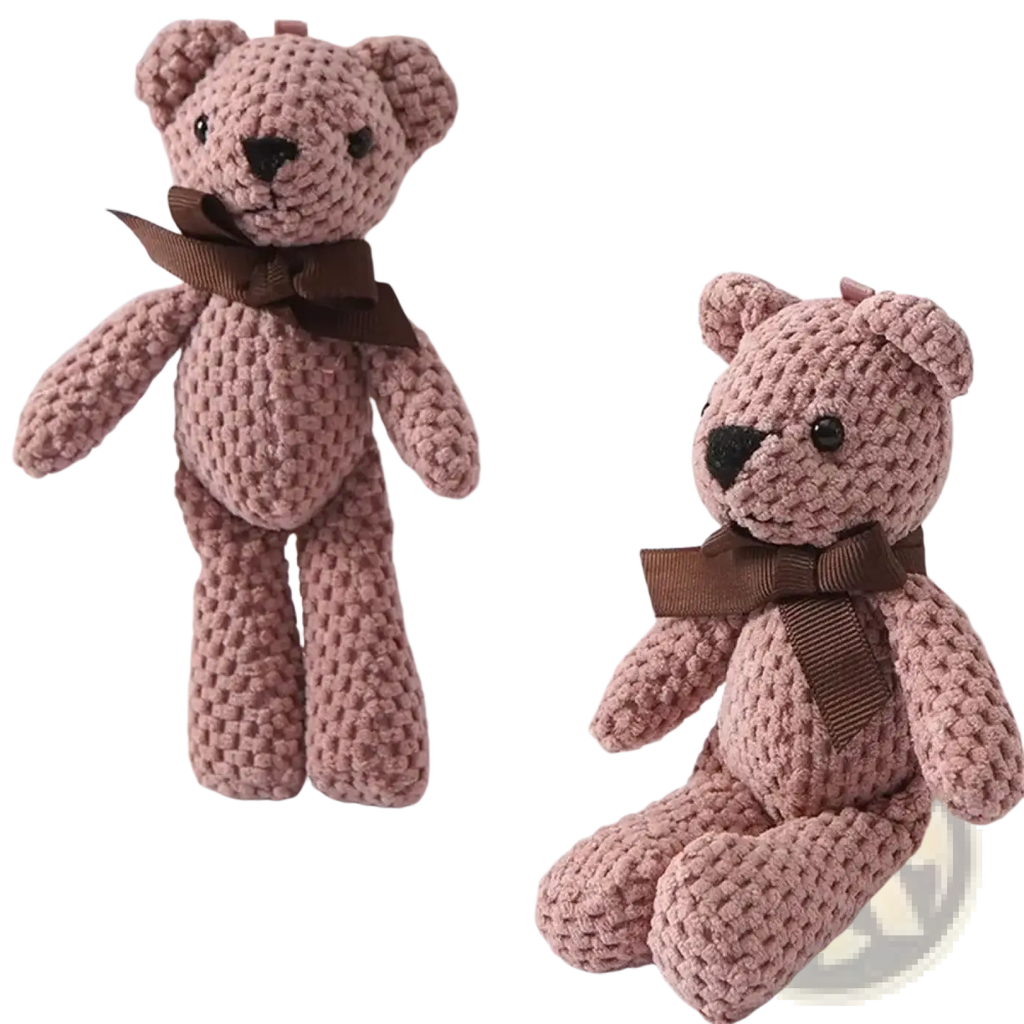 Two handmade crochet teddy bear plush toys knitted in pink with brown ribbon bows around their necks