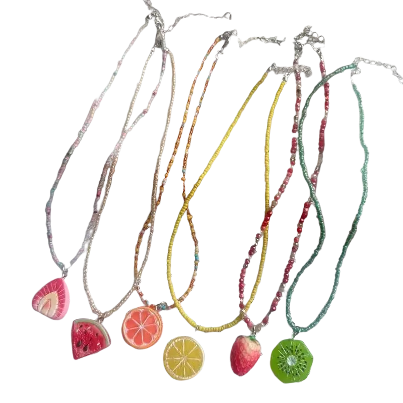 Handmade bohemian beaded pendant necklace collection with vibrant fruit-themed colorful pendants