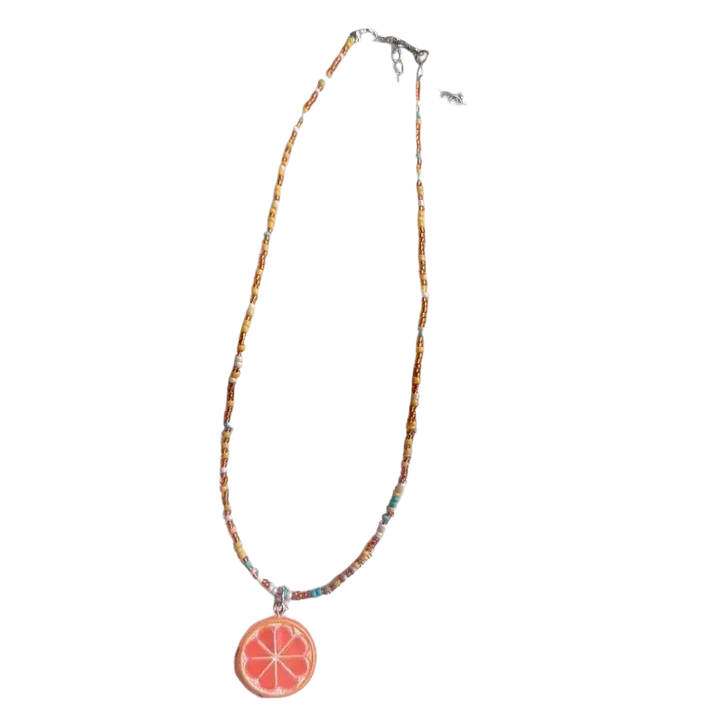 Handmade bohemian beaded pendant necklace with vibrant orange citrus slice and multicolored yellow blue beads