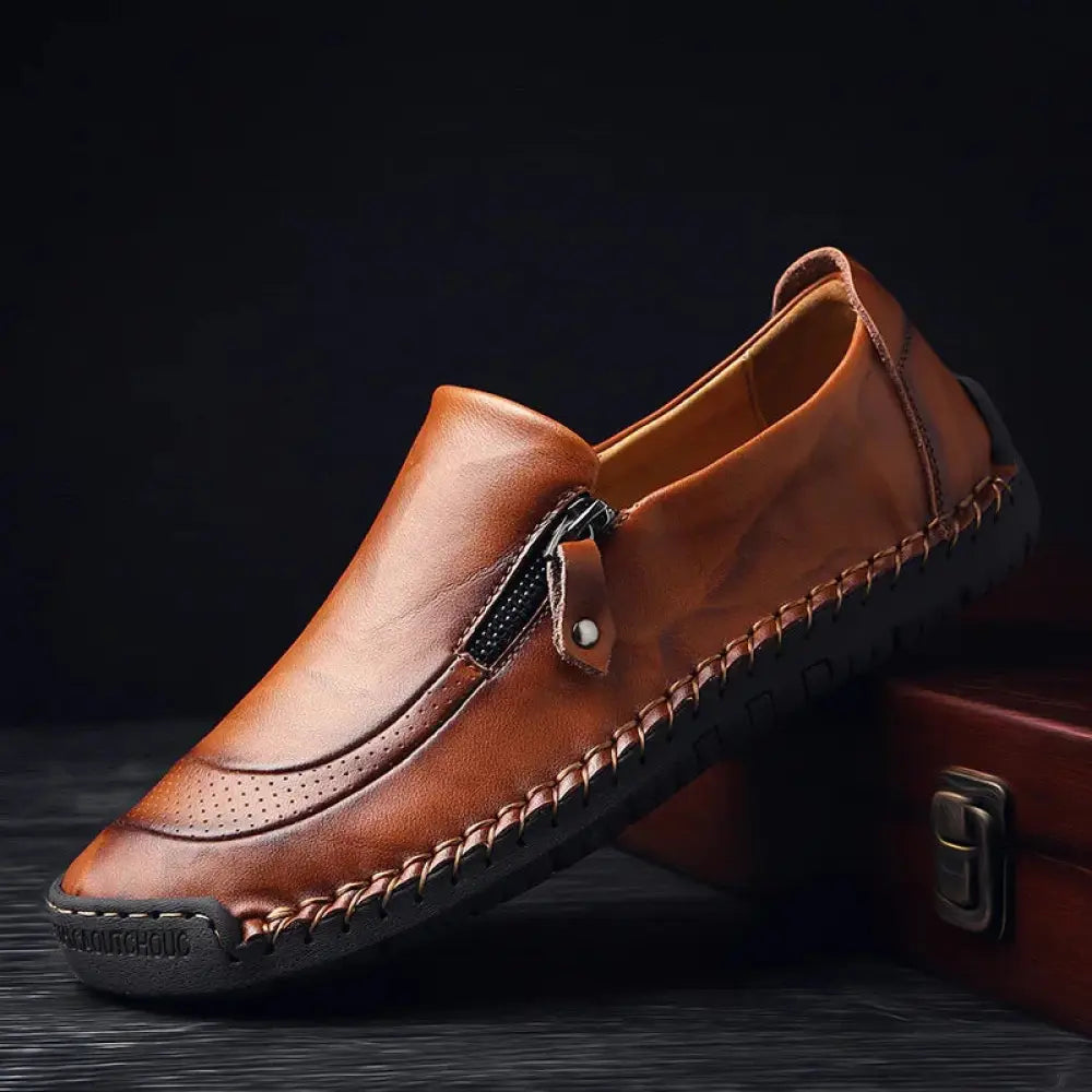 Men’s handcrafted brown leather slip-on loafer with visible stitching and side zipper detail dress shoe