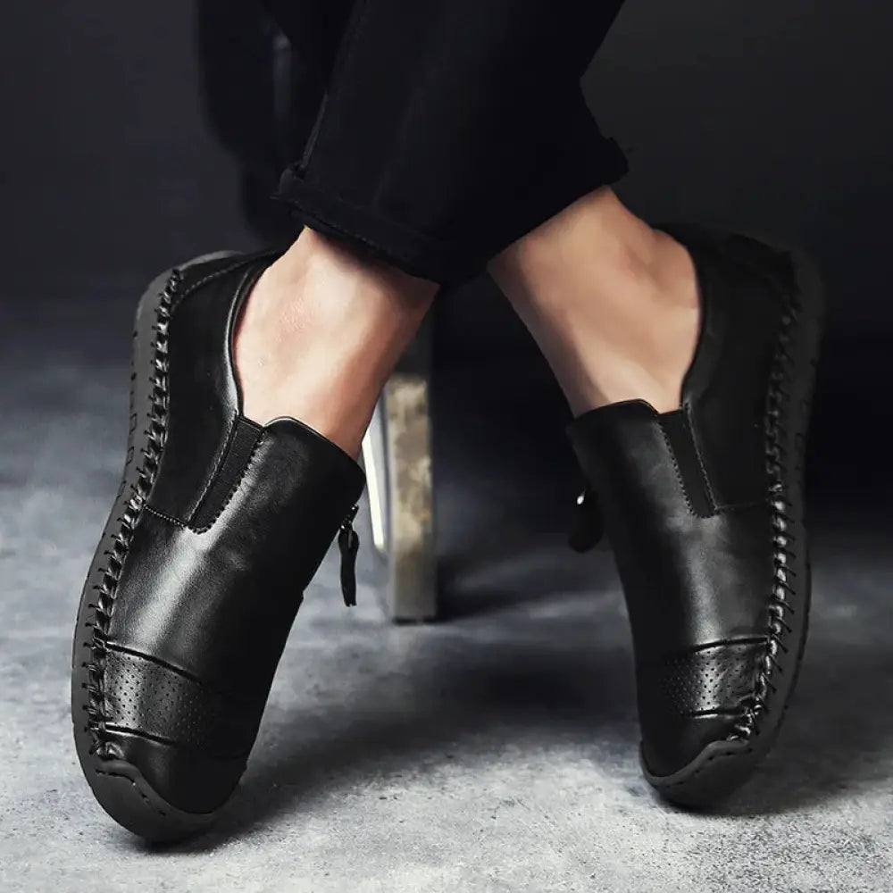 Men’s handcrafted black leather slip-on oxford dress shoes with visible side stitching and inner side zipper closure