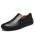 Men’s handcrafted black leather slip-on loafer with zipper closure and visible stitching along the sole