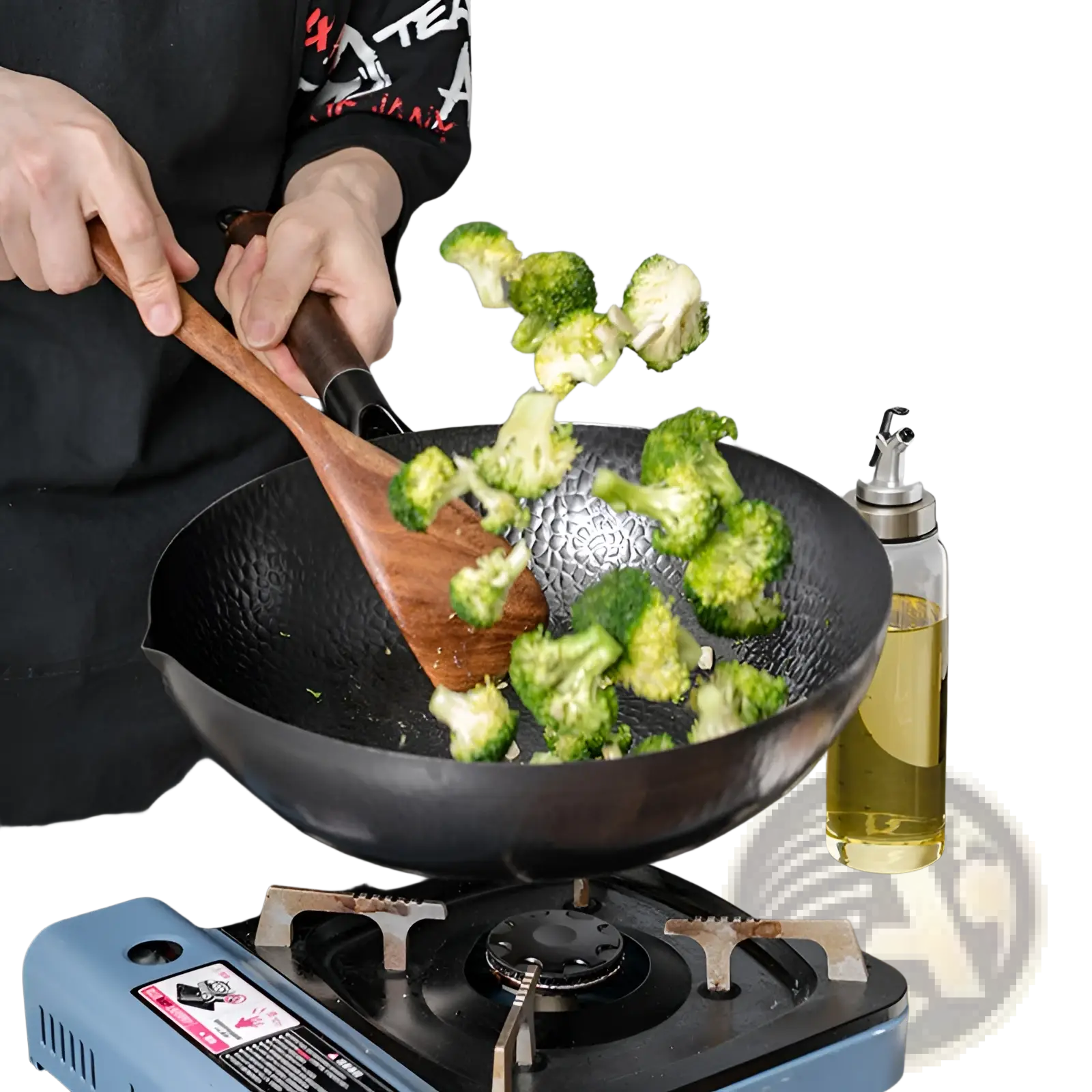 Handmade black textured iron wok with wooden handle and wooden spatula for versatile cooking use