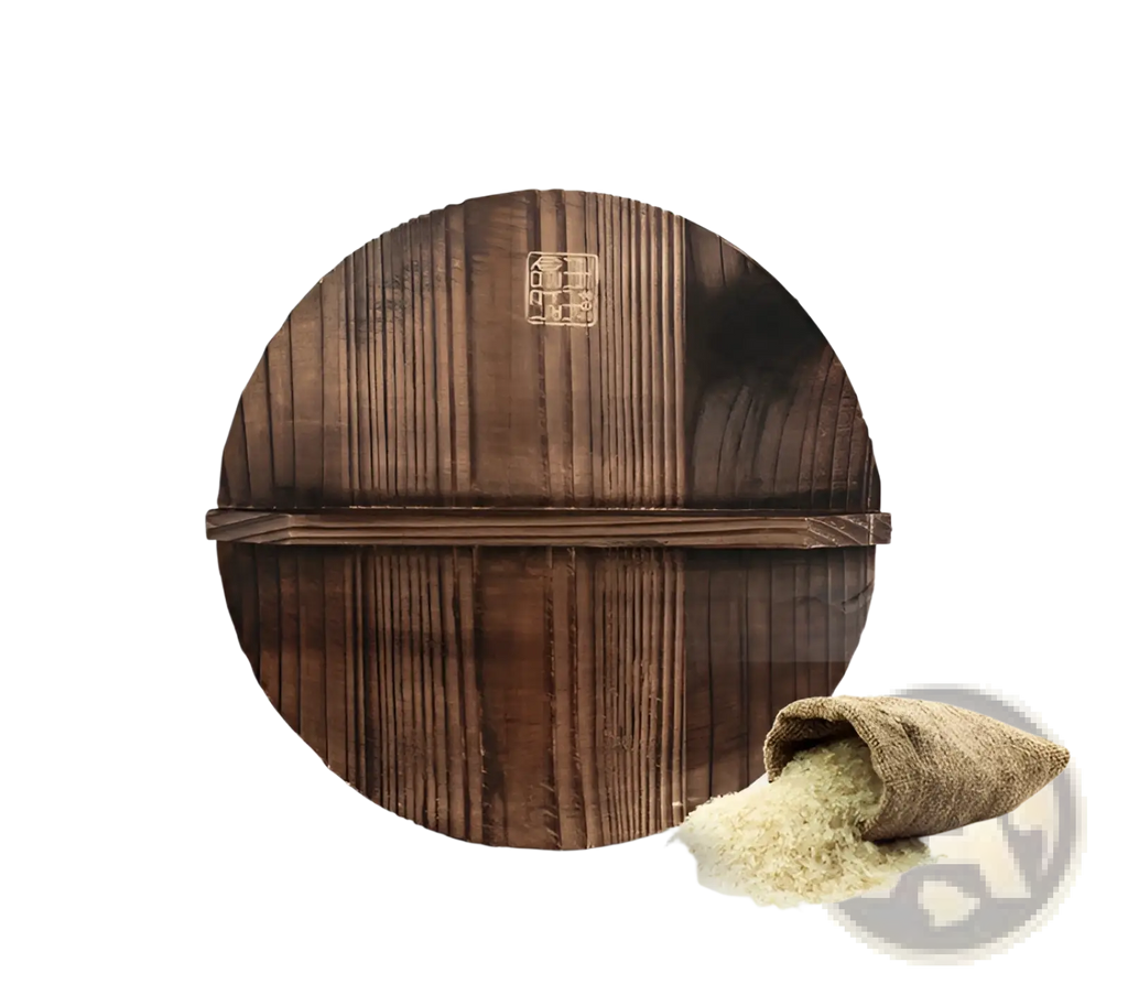 Dark brown wooden circular rice mortar with vertical grooves and central metal emblem paired with handmade iron wok with wooden handle and glass lid