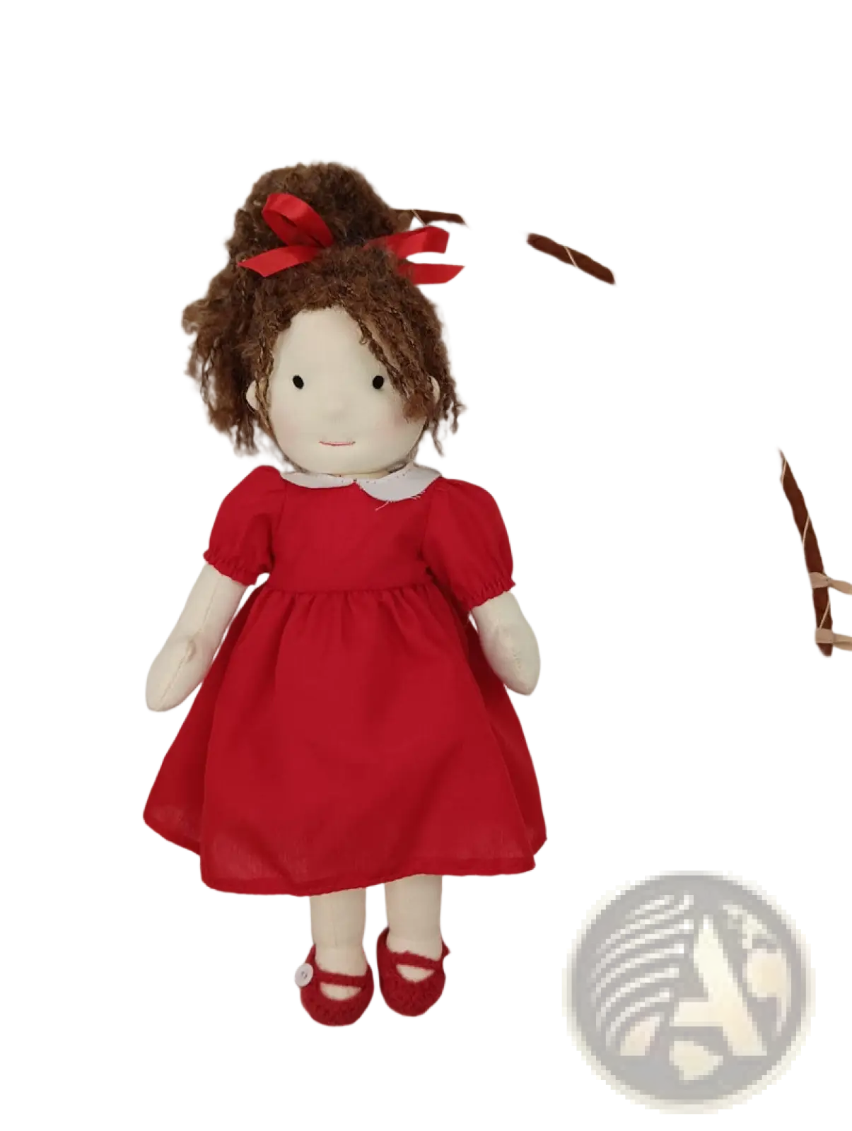 Handmade plush doll with golden curly brown hair tied in a bun with red ribbons wearing a red dress and shoes