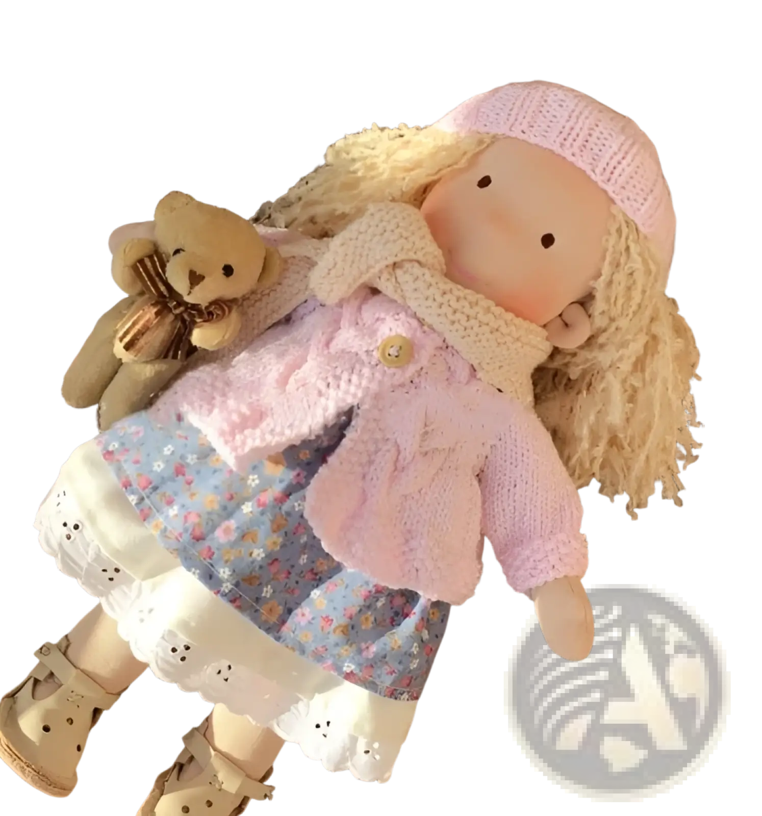 Handmade plush doll with golden curly hair in soft pink knit hat and scarf wearing floral skirt with white lace trim
