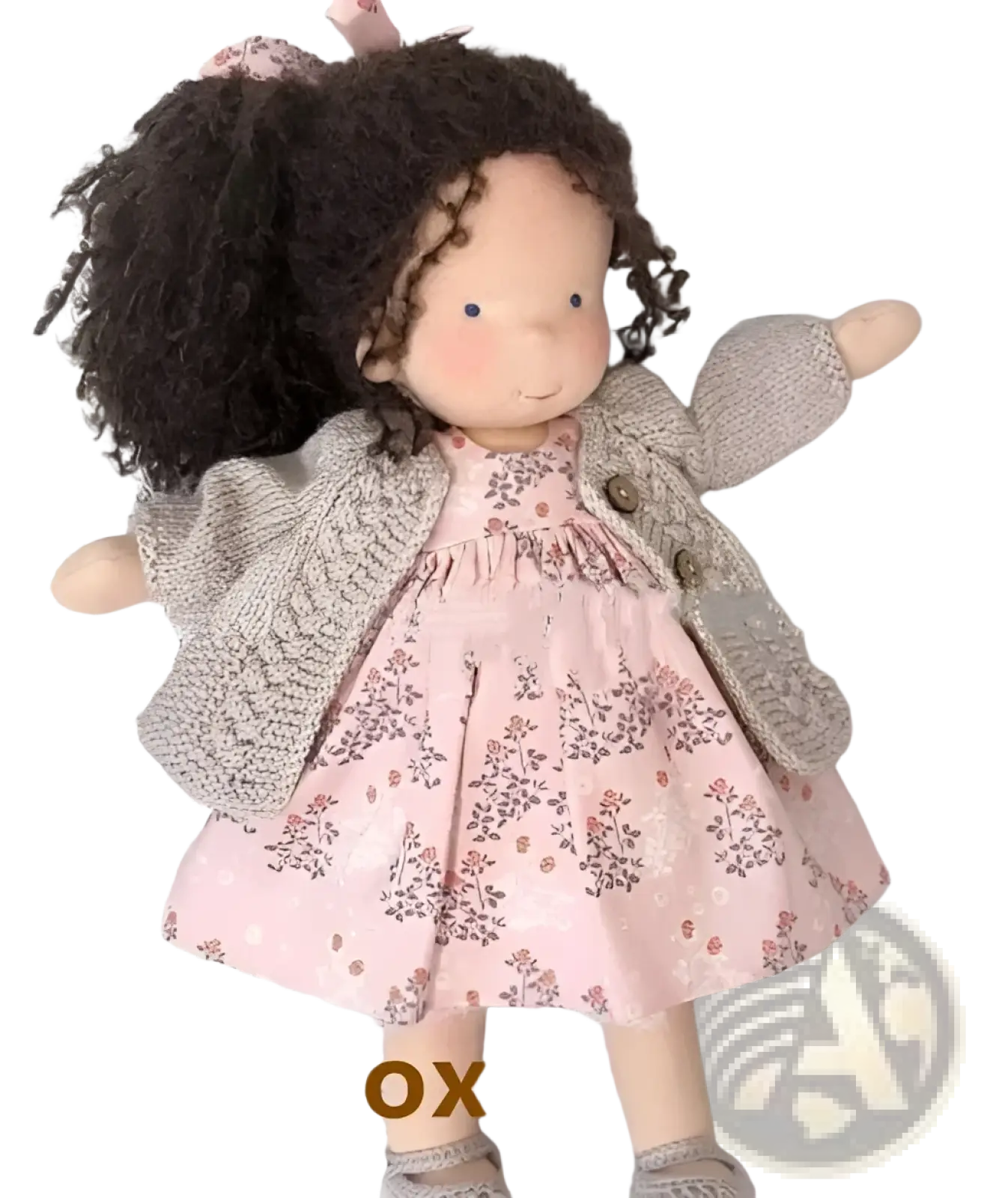 Handmade plush doll with curly dark brown hair wearing a pink floral dress and gray knitted cardigan 30cm tall