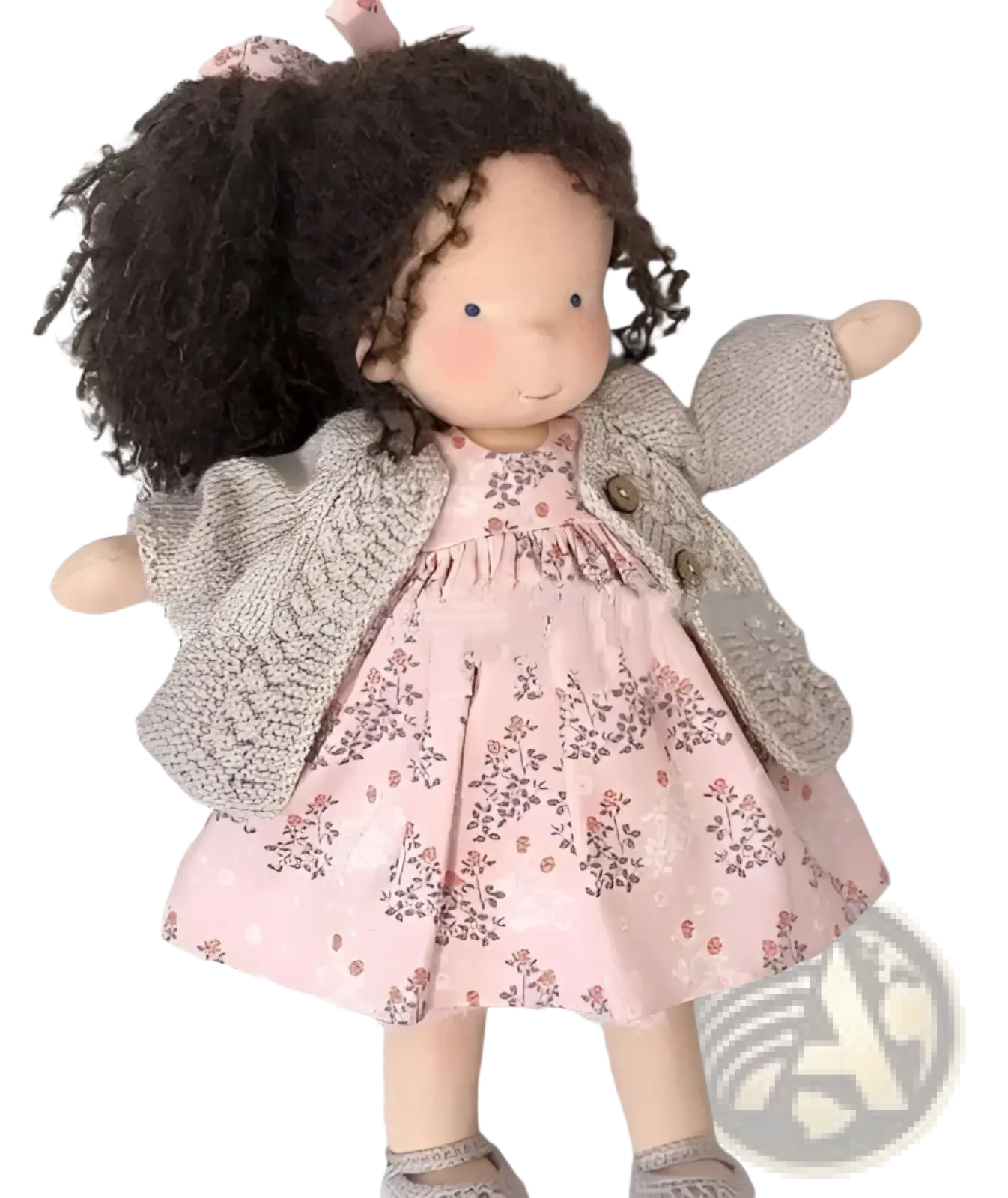 Handmade plush doll with curly dark brown hair wearing pink floral dress and gray knitted cardigan 30cm tall