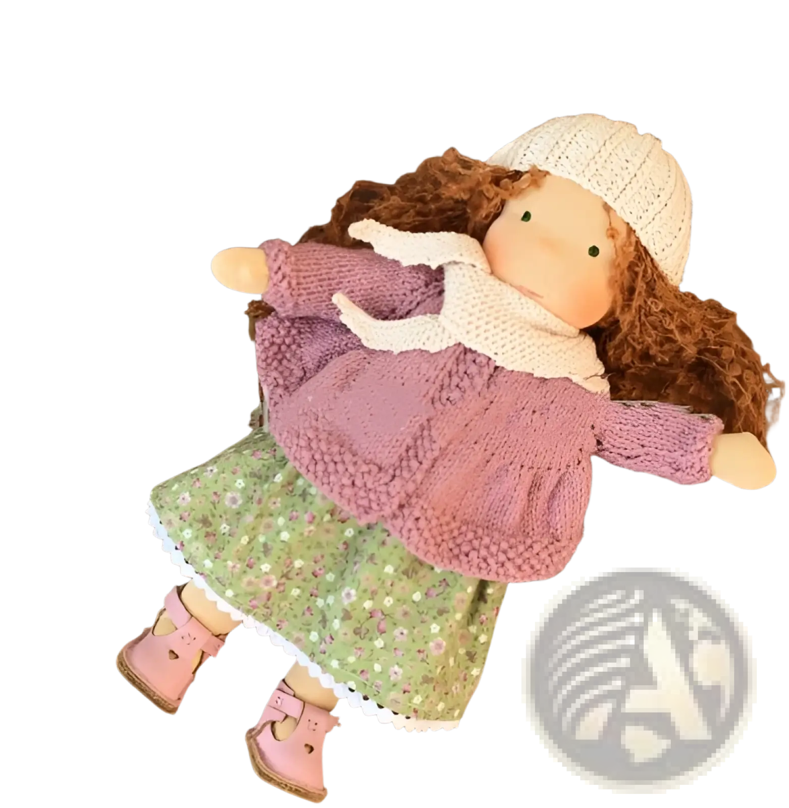 Handmade plush doll with golden curly hair wearing a knitted white hat and pink sweater over green floral skirt