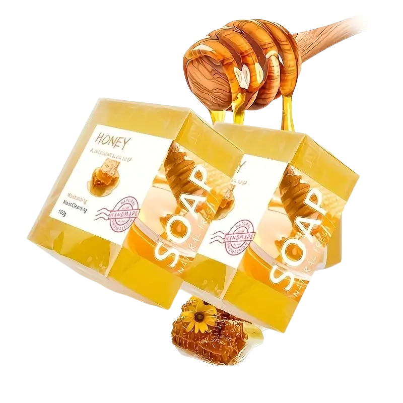 Handmade soap natural honey essential oil in golden bars with clear packaging and wooden dipper dripping amber honey