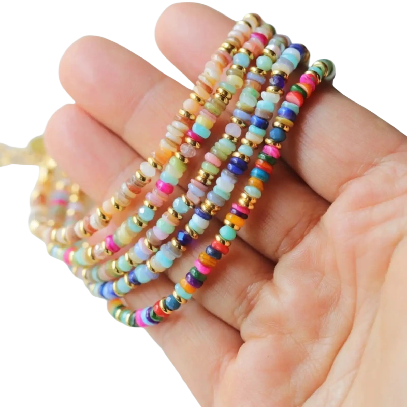 A hand holds colorful handwoven rainbow shell beaded stretch bracelets with opal-like beads and gold spacers